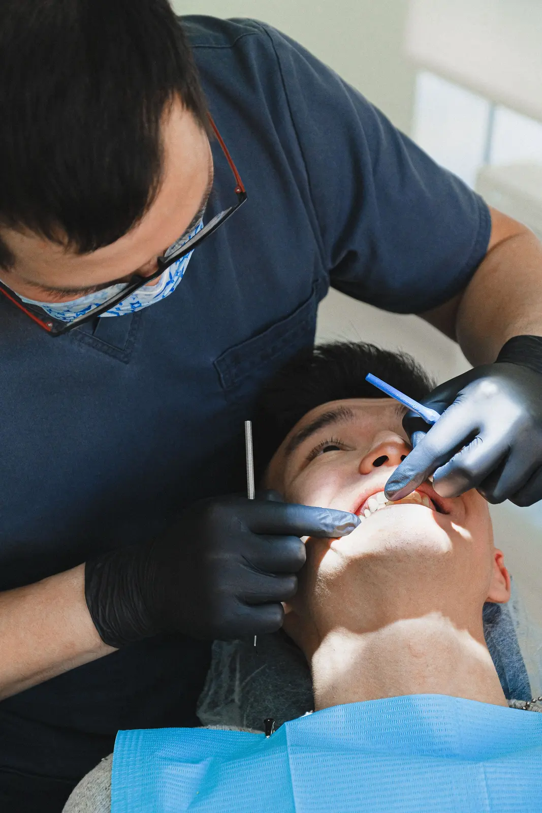 Careful chairside work on a single tooth, alongside the Full Mouth Implants explanation in Victoria