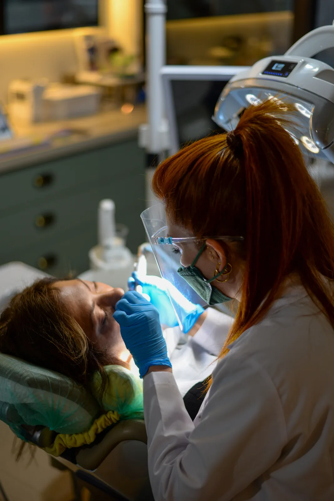 Curing light used during chairside treatment, shown while covering Dental Implant Cost in Victoria