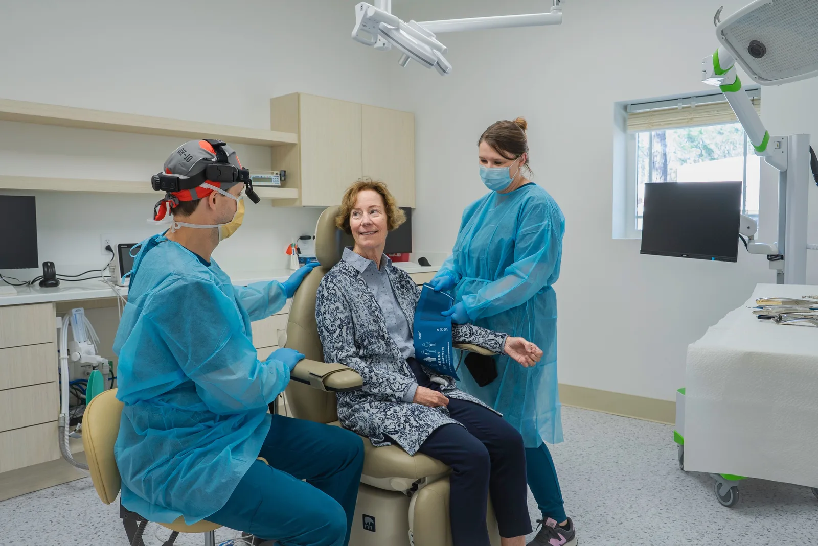 Dental team with a patient in the operatory, shown while covering Socket Preservation in Victoria