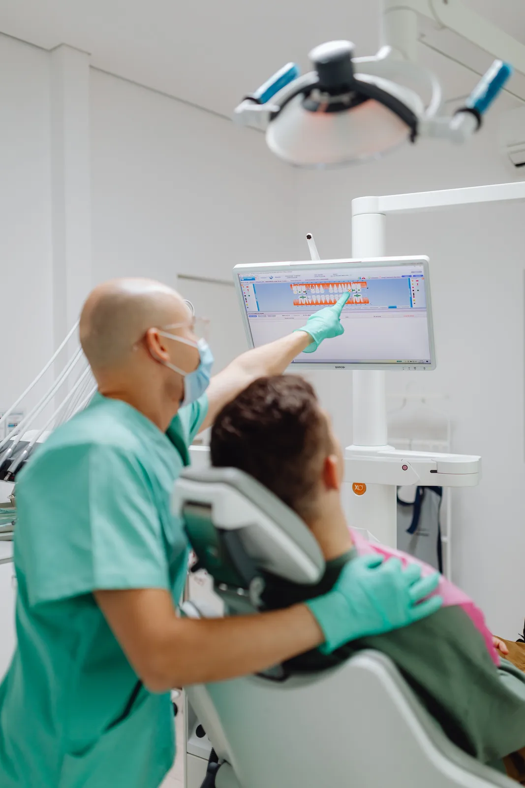 Reviewing the treatment plan on the chairside screen, alongside the Dentures Vs Implants explanation in Victoria