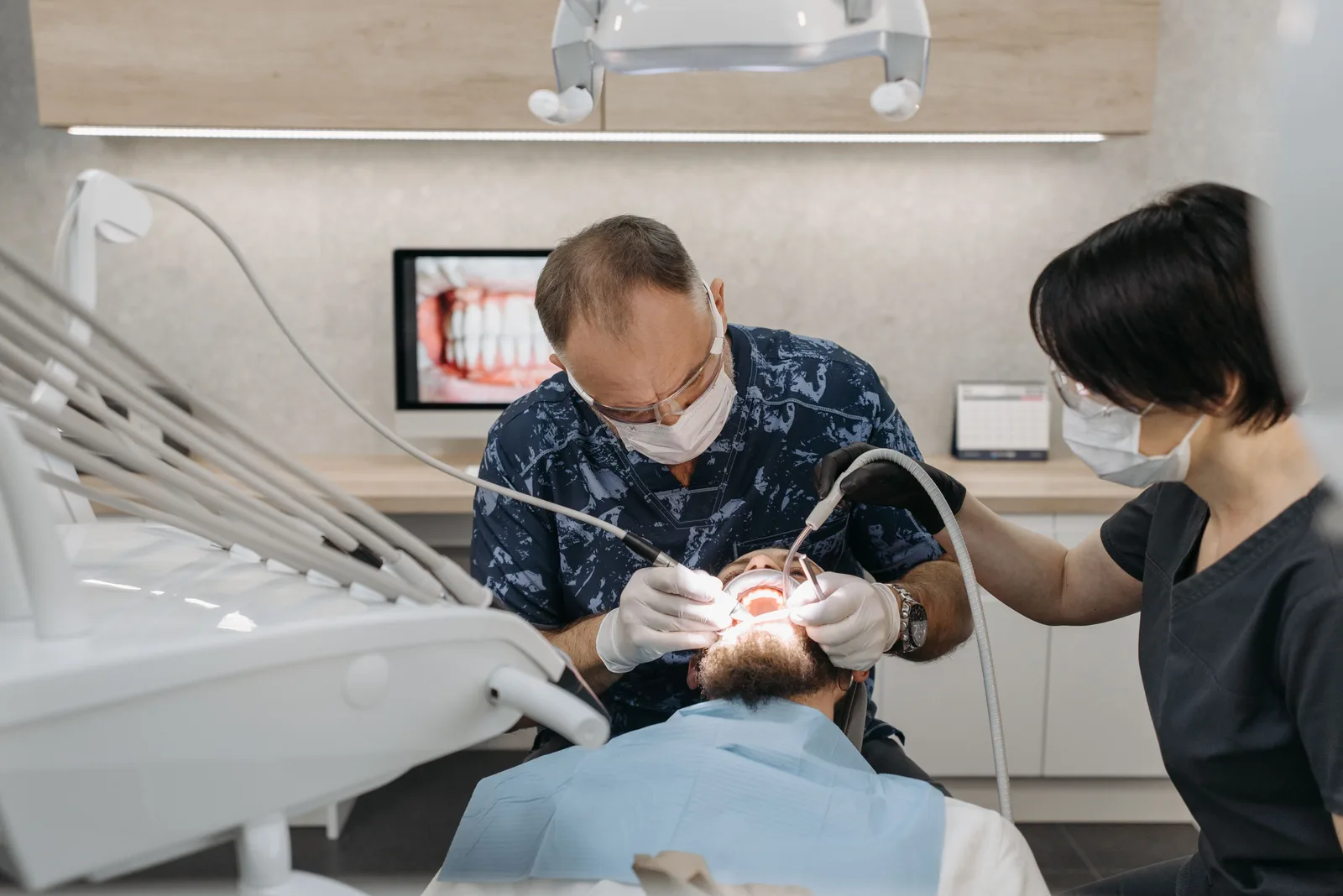Dentist and assistant working together during treatment, referred to in the All-on-6 Implants section for Victoria