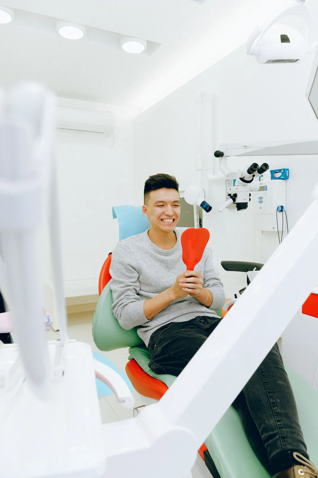 Young patient pleased with the result, referred to in the Front Tooth Implant section for Victoria